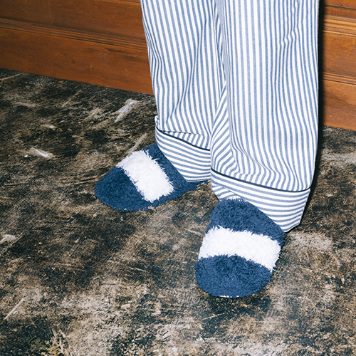 ネイビーボーダーのサンダルを履いた男性モデル